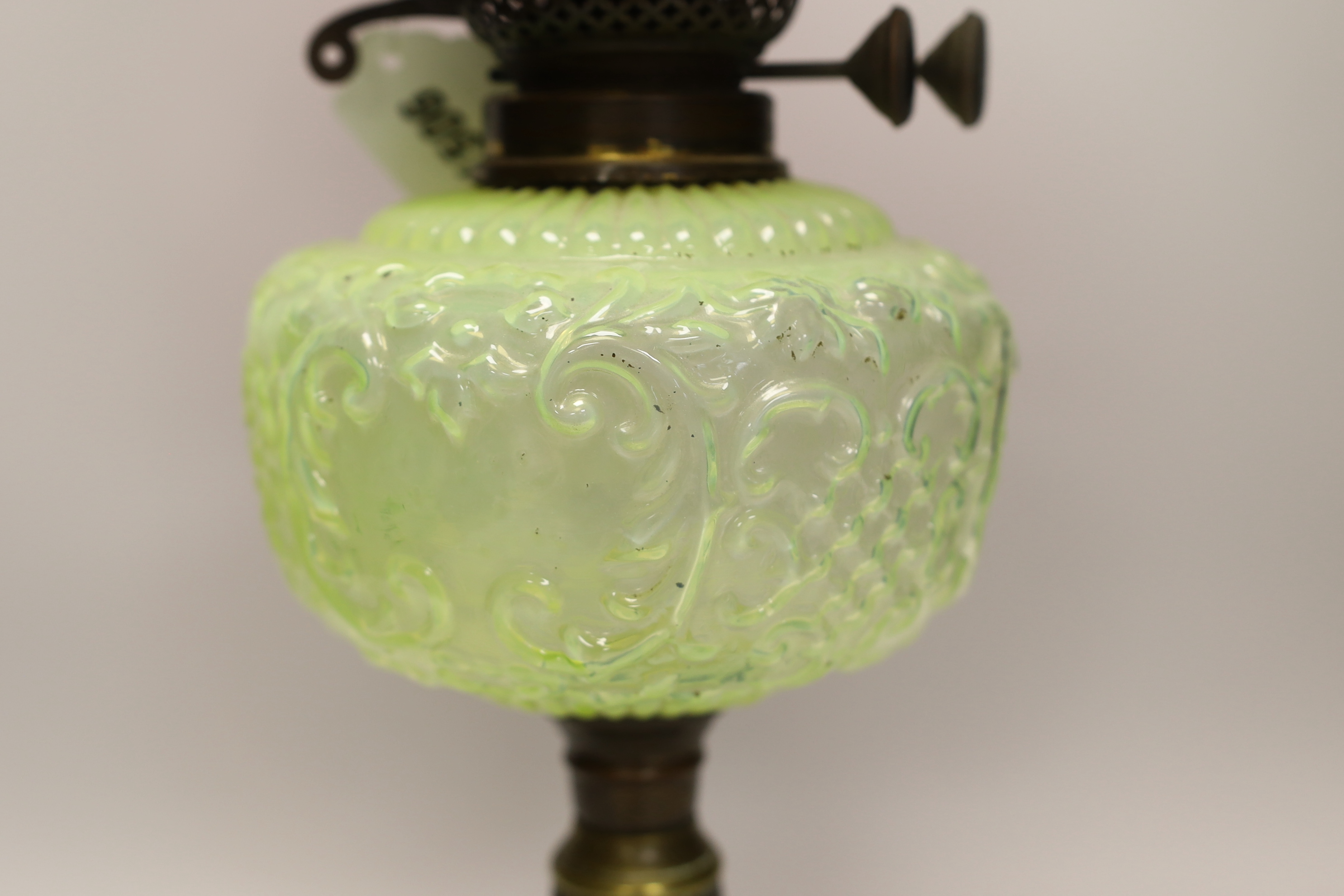 A Victorian brass and glass oil lamp, with cranberry shade, 58cm high including funnel